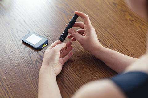 Fingerprick using a lancet.
